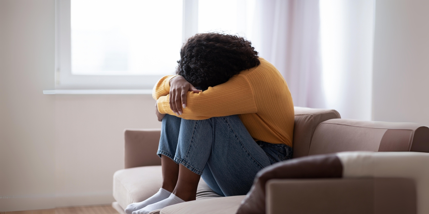 woman crying on couch